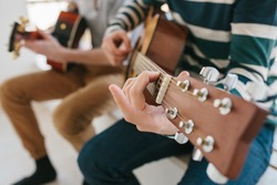 Learning to play the guitar. Music education and extracurricular lessons. Hobbies and enthusiasm for playing guitar and singing songs.
