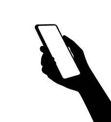 A silhouette of a smartphone in person hand. Using new computer technologies and applications for mobil phones.