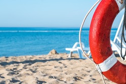 life preserver on a background of the sandy beach and the sea, Lifebuoy