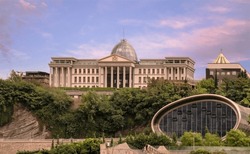 Summer sunset view of Ceremonial Palace of Georgia towering above Nikoloz Baratashvili Rise with oval glassy front wall of Rike concert hall in the heart of the city of Tbilisi Tiflis, capital of