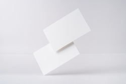Design concept - front view of 2 surreal white business card float on mid air isolated on white background for mockup, it's real photo, not 3D render