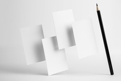 Design concept - front view of 4 surreal white business and black pencil card float on mid air isolated on white background for mockup, it's real photo, not 3D render