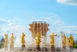 Fountain Friendship of Peoples or Friendship of Nations of the USSR on VDNH park in Moscow. Soviet architecture with sixteen  woman golden statues in Russian Moscow.