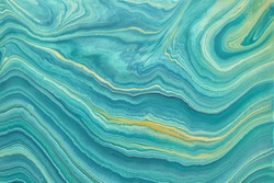 Abstract fluid art background blue and golden glitter colors. Liquid marble. Acrylic painting on canvas with turquoise gradient. Watercolor backdrop with cyan wavy pattern. Stone section.