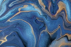 Abstract fluid art background navy blue and brown colors. Liquid marble. Acrylic painting on canvas with golden lines and gradient. Alcohol ink backdrop with sapphire wavy pattern.