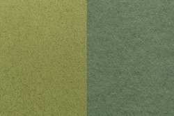 Texture of craft dark green and olive paper background, half two colors, macro. Structure of vintage khaki dense craft cardboard. Felt backdrop closeup.