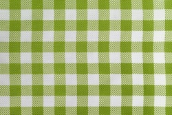 Checkered tablecloth for the table in green and white cells. Background texture of olive textile napkin. Plaid fabric. macro.