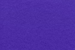Texture of navy blue and dark violet colors paper background, macro. Structure of dense craft indigo cardboard. Felt backdrop closeup.