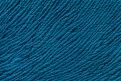 Blue background from a soft wool textile material closeup. Fabric with natural texture. Cloth backdrop.