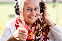 Happy Senior Woman Loves Music and Fun