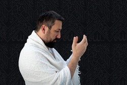Muslim pilgrims in white traditional clothes, praying at Kaaba in Makkah. High quality photo