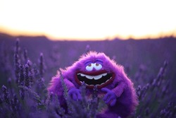 Fluffy toy Art from Monsters Inc cartoon sits in a lavender field