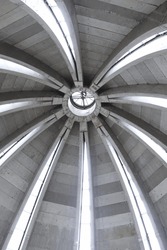 Radial beams of the reinforced concrete structure of the dome. High arched windows. A round window at the top of the church dome lets in sunlight