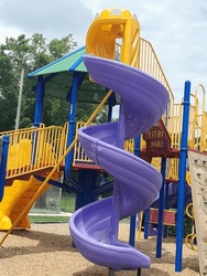 purple spiral long twisted plastic sliding board attached to yellow steps