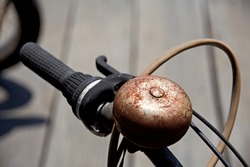 Old motorcycle with handbrake and rusted bell