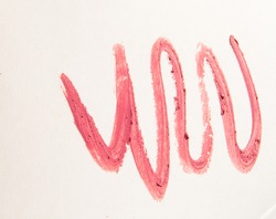 Zigzag lines of pink lipstick, strokes on a white background.