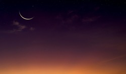 Islamic Moon sky on Dark Blue Dusk,Twilight Sky in the Evening with Sunset and Beautiful Sunlight dark cloud and Crescent moon, symbol of religion islamic begin Ramadan month, Eid al-Adha, Eid al fitr
