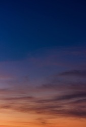 Colorful sunset sky vertical in the evening on twilight with orange sunlight on dark blue hour background 