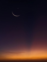 Crescent moon on dusk sky twilight vertical in the evening symbol religion of Islamic well editing text  Ramadan Kareem, Eid Al Fitr, Eid Mubarak, Eid Al Adha on free space background