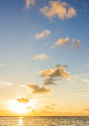 Sunset sky clouds vertical over sea in the evening on summer season with orange sunlight golden hour background  