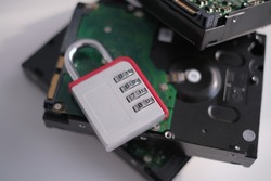 Encrypted hard disk. Padlock with cipher on an opened hard disk. Data loss. computer motherboard. the concept of data, hardware, information technology and cyber security.