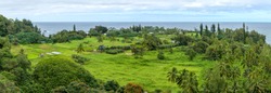 Seaside Village - A panoramic view of a tropical seaside village at Keanae Peninsula of east Maui, as seen from the Road to Hana Highway, on a cloudy afternoon. Hawaii, USA.