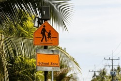 School district sign with palm trees in the background