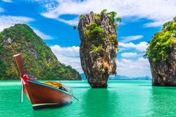 Landscape of amazing James Bond island with longtail boat waiting for traveler on tropical sea beach near Phuket, Travel nature adventure Thailand, Destination place Asia, Summer holiday vacation trip