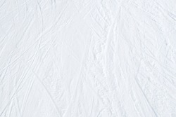 Top view of white ski tracks pattern on snow background.