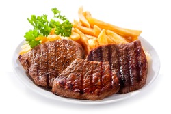 plate of grilled meat with fries on white background