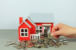 A Hand Selecting A Coin. Releasing Equity In Your Home Concept.