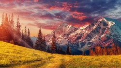 Awesome alpine highlands in sunny day. Scenic image of fairy-tale Landscape with colorful sky under sunlit, over the Majestic Rock Mountains. Wild area. Megical Natural Background. Creative image .