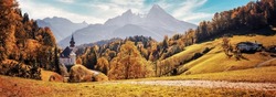 Stunning Autumn landscape. Scenic view on Maria Gern church with mountains on background. Vivid atmospheric nature scenery. Natural background. Iconic location for landscape photographers.Formats