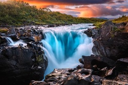 Scenic image of Iceland. Great view on waterfall with colorful sky during sunset. Wonderful Nature landscape. Travel is a Lifestyle, concept. Iceland popular place of travel and touristic location.	