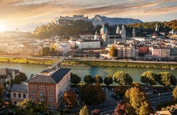 Colorful evening cityscape. Panoramic view on historic city of Salzburg with famous Hohensalzburg Fortress. Wonderful autumn landscape with picturesque sky. Softlight effect. Salzburger Land, Austria