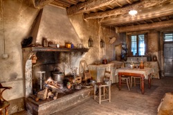 old times farmhouse - interior of an old country house with fireplace and kitchen