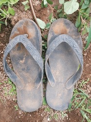 A pair of dirty black sandals