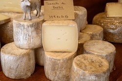 Farmer shop in La Grave ski village, Hautes Alpes, France, cheese for sale, lettering in French means Tomme from Sheep milk, farmers cheese, close-up