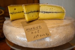 Farmer shop in La Grave ski village, Hautes Alpes, France, cheese for sale, lettering in French means Morbier cheese, farmers cheese, close-up