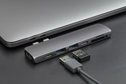 Close-up photo of laptop, type-c hub with cable and usb receiver