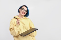 A female designer in yellow hoody holding graphic tablet. The white background