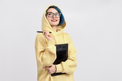 A female designer in yellow hoody holding graphic tablet. The white background