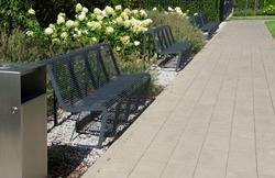 Modern metal bench in park. Outdoor benches, city architecture, outdoor chair, urban public furniture, empty plank seat, comfortable bench in recreation area