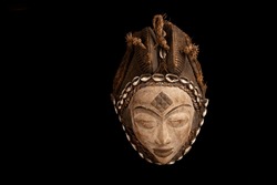 Traditional African tuna (beauty) mask from Gabon against a black background