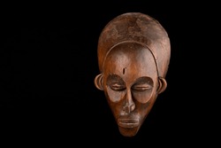 Traditional African mask against a black background
