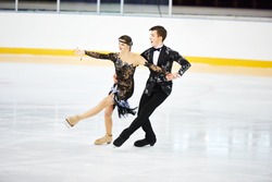 figure skating of young skaters pair at sports arena