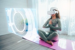 The Hispanic woman wearing VR goggles and doing Yoga and dancing at home, the concept of metaverse, versual really, activity, cyberspace and future