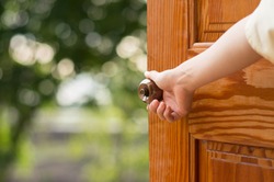 Women hand open door knob or opening the door.