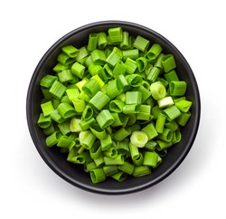 Bowl of chopped spring onions isolated on white background, top view