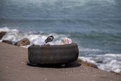 Trash bin made of used tires, with garbage piled up, on the edge of Glagah beach, Kulonprogo, Yogyakarta